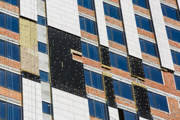 Thermal insulation of a house wall on a building site