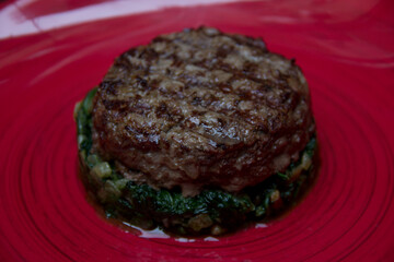 fried meat on a spinach pillow close-up. Dish of meat. Meat food