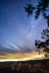 Fototapeta premium Milkyway rising over a mountain ridge with clouds on the horizon 