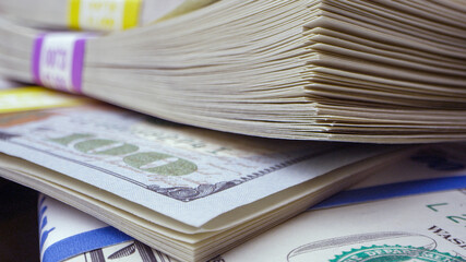 Macro view of money wrapped and piled up viewing the details of the bills.