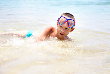 Portrait of a boy wallowing on the seashore. NaiYang beach. Andaman sea.