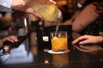 orange drink being poured 