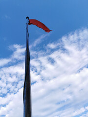 Red flag at the beach is to prohibit the visitors who come to the beach to aware of sea wave during...