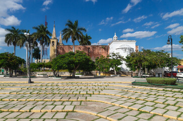 Santa Ana park and church with tropical trees, Merida, Yucatan, Mexico