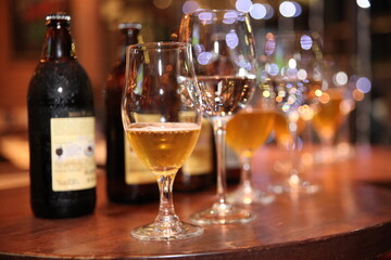 beer tall glasses aligned with bottles