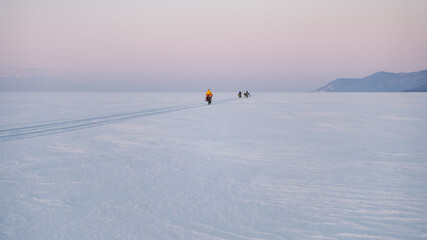 Fototapeta premium Byciclists on Baikal Lake in winter