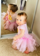 Close up Portrait of Sweet and Cute 11 Month old baby girl,  toddler in pink tutu skirt