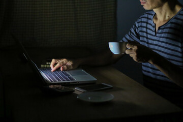 Asian man working late at home at night. Working from home concept.