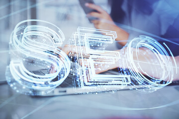 Double exposure of woman hands working on computer and seo hologram drawing. internet search...