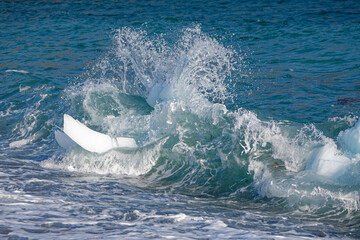 Fototapeta premium Small sections of an iceberg that have broken off and washed up on the beach, Newfoundland and Labrador, Canada.