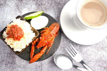 Flatlay picture of "nasi lemak" with "sambal" or spicy sauce fresh water lobster and a cup of coffee.