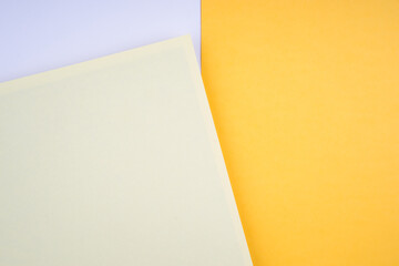 Creative arrangement of soft pastel colored papers creating an abstract background