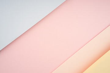 Creative arrangement of soft pastel colored papers creating an abstract background