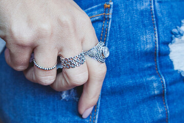 young woman with a necklace and rings