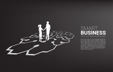 Silhouette of businessman and businesswoman handshake on brain graphic. Concept of team work partnership and cooperation strategy.