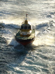 Pilot Boat coming alongside a large ship.