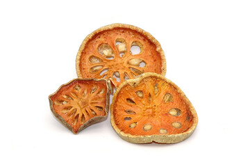 Dried sliced Bael fruit isolated on white background. Bael fruit has anti-inflammatory property, helps to heal digestive disorders, used as a remedy for asthma, and common cold. Herbal tea ingredients