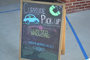 Cubside Pickup & Limited Browsing Coronavirus Sign Written in Chalk on a Blackboard. 