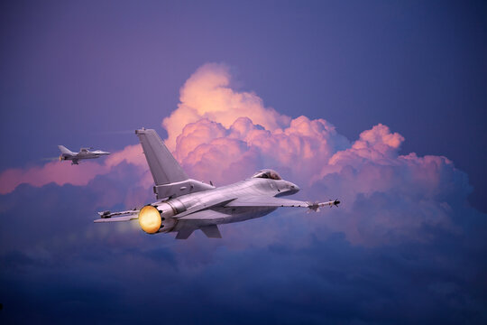 F-16 Fighting Falcon jets (models) fly toward pink and purple clouds at sundown