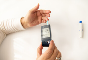 Woman Hands Testing Her Blood Sugar level With Glucometer