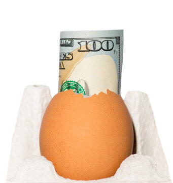 roll of money, one hundred dollar bills inside a broken egg