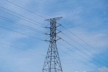 Power line tower with blue sky with clouds. 