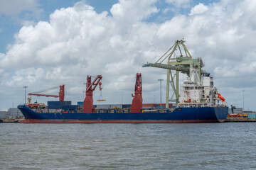 Cargo ship at port to load and unload containers. 