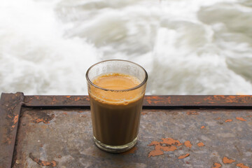 tea served in a glass along the river side