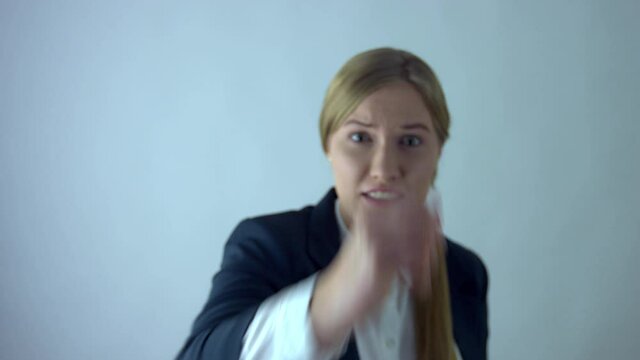 Businesswoman hitting screan with fist like there was some virtual emergency button.