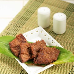 Empal or Gepuk is Indonesian Fried Meat with Traditional Herb and Spiced. It Taste Sweet, Tasty, Tender, and Delicious. Usually Served with Sambal and Rice