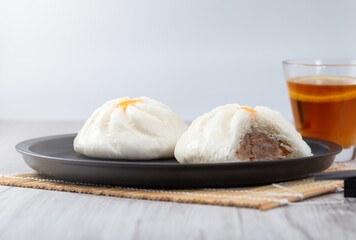 Chinese steamed buns with tea in a black dish Popular in Asia