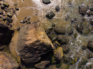 Ocean beach, top view for design, rocks and stones.