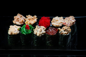 Sushi Roll On A Black Background reflection . Japanese food. Close Up.