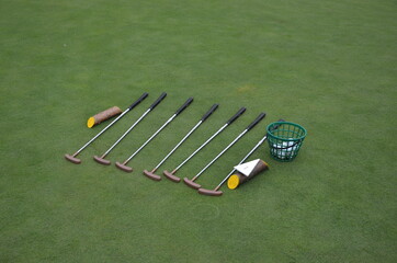 Golf ball and Golf Club on green grass background