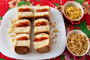 mini hot dogs with tomato sauce, potato sticks and corn