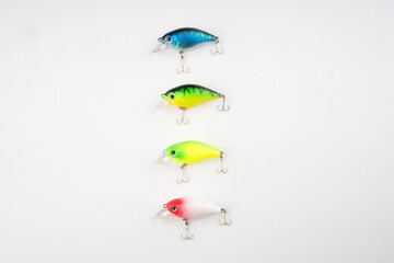 Obraz premium Creative arrangements of wobbler lures. Fishing lure with hooks. Plastic fish with hooks. Flat lay or top view.