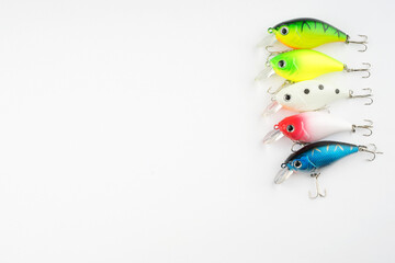 Creative arrangements of wobbler lures. Fishing lure with hooks. Plastic fish with hooks. Flat lay or top view.