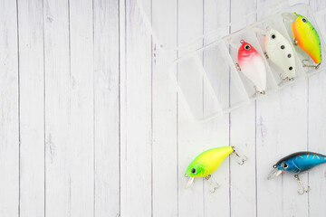 Creative arrangements of wobbler lures. Fishing lure with hooks. Plastic fish with hooks. Flat lay or top view.