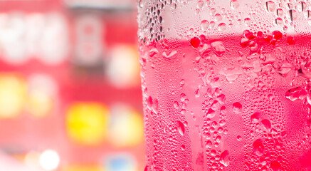 red soda water splashing with bubbles close up and Dew Point on glass