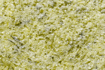 Natural cosmetic face body scrub texture. Green herb and sugar scrub closeup. Beauty spa product background
