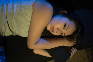 Asian girl suffering depression - sad and depressed Japanese woman crying on darkness in pain...