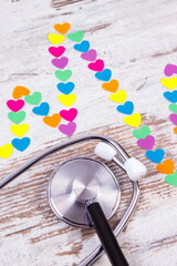 Cardiogram line of paper hearts and stethoscope, medicine and healthcare concept