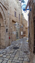 Jerusalem white stone house on narrow street of Old Yafo (Jaffa). Tel Aviv, Israel.