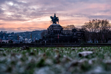 Fototapeta premium Colorful Sunrise burning sky Koblenz City historic monument German Corner where river rhine and mosele flow together