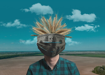 The concept of the agricultural crisis during the virus and quarantine. In the photo, a farmer in a medical mask of dollars and wheat, against the background of an empty field