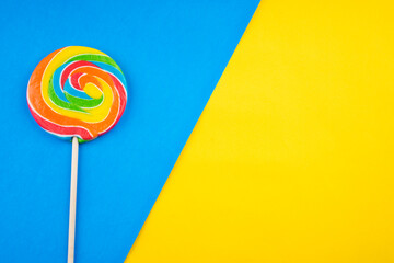 Candies and Sweets concept. Colorful lollipops on vibrant colored background
