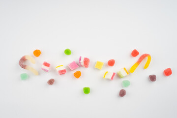 Abstract arrangement of candies and sweets on multi colored background