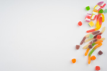 Abstract arrangement of candies and sweets on multi colored background