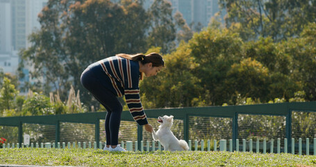 Woman plays with her dog at park
