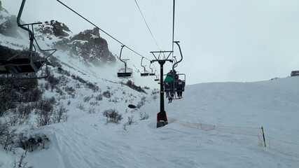 Fototapeta na wymiar skiers on ski lift